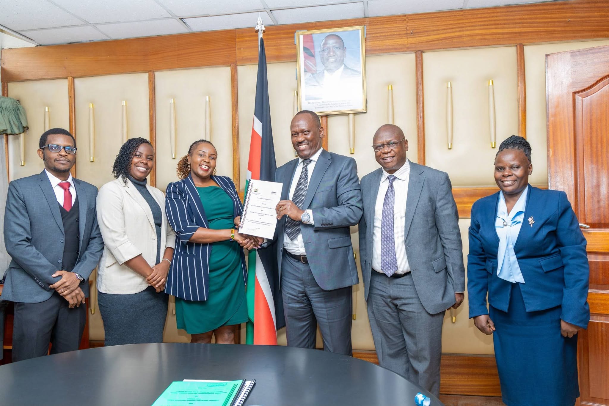 Mr. Josiah Musili, EBS and RELI Africa Kenya Coordinator, Ms. Nyambura Thiong'o, display the signed MOU during the partnership signing event.